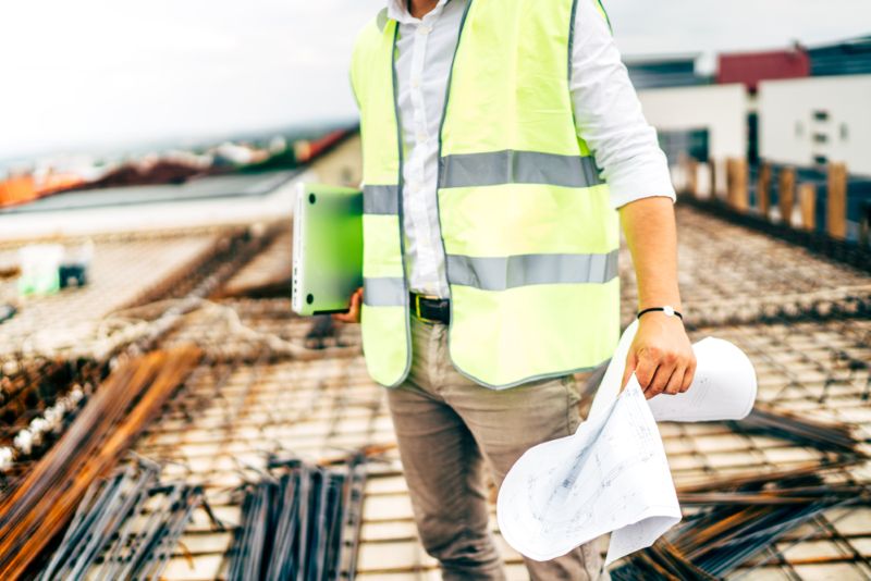 Construction worker reviewing plans on construction site