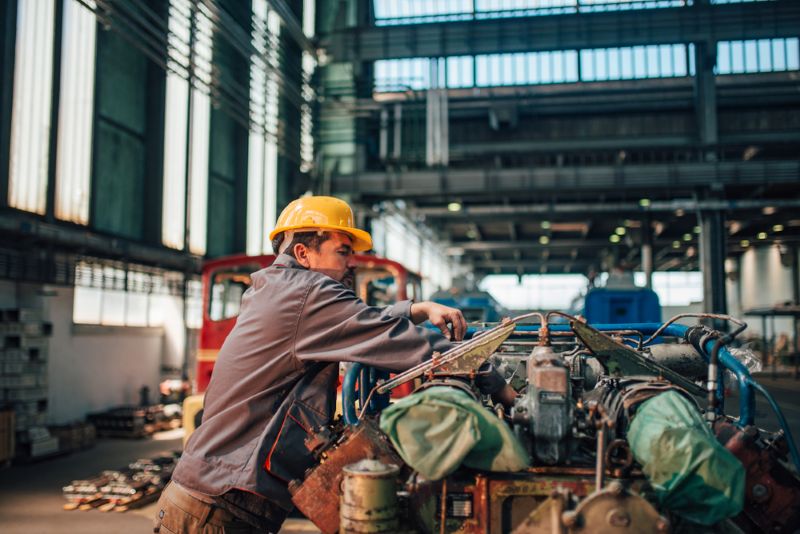 Factory worker working on a machine