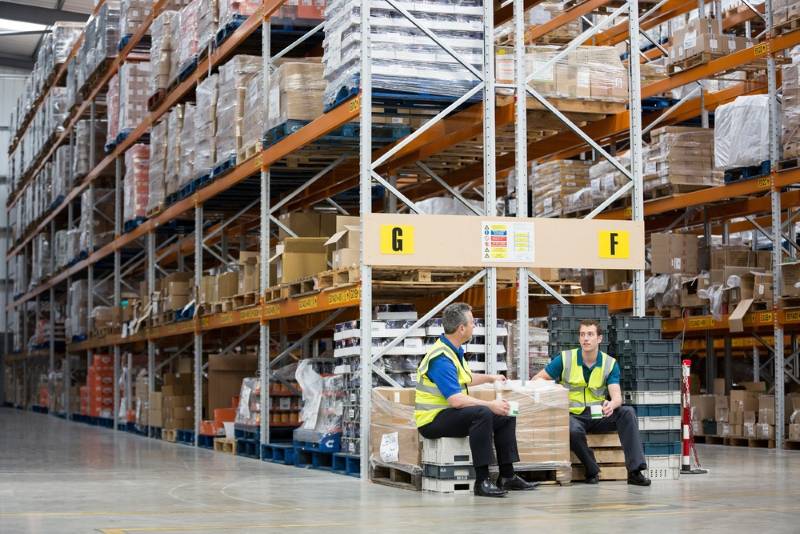 Two warehouse workers chatting while on a break