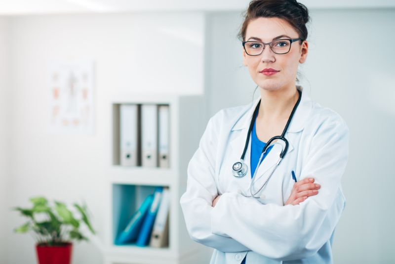 Doctor standing with her arms folded