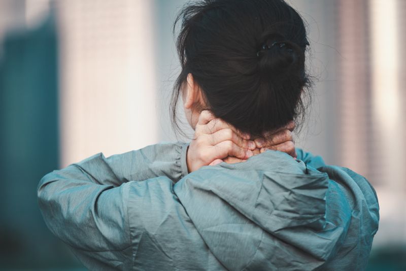 Woman experiencing serious neck pain