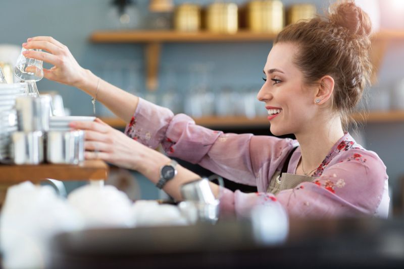 Barista at work with a smile on her face