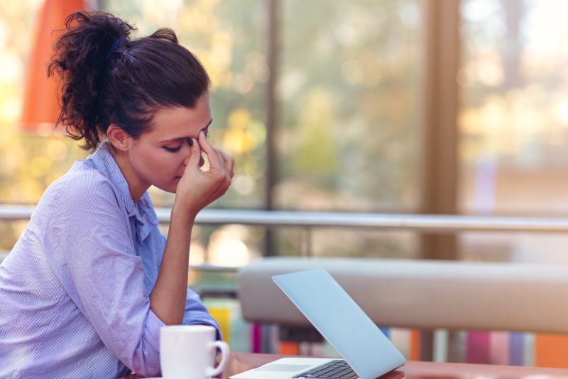 Frustrated woman working on her laptop