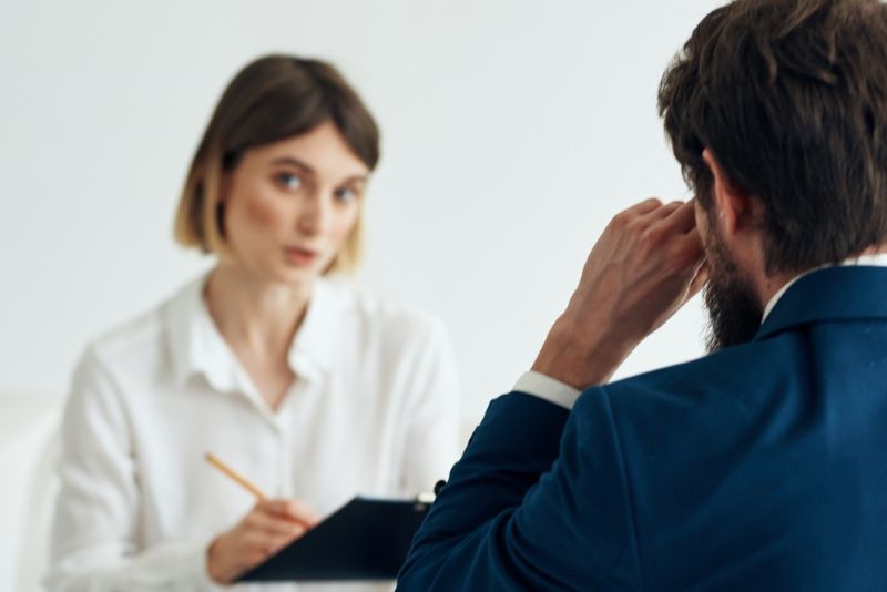 Employer speaking with worker and taking notes