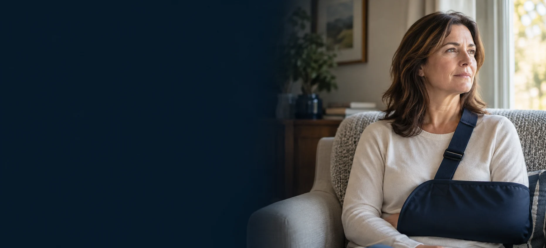Woman recovering at home with her arm supported in a sling